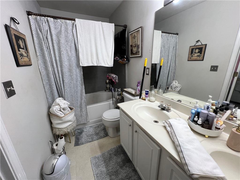 3914 Howell Park Road Duluth, GA 30096 - Photo 16 of 33 a bathroom with a sink a toilet and a mirror