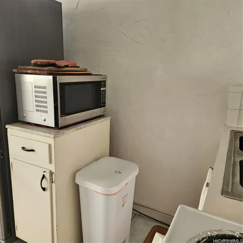 a bathroom with a stove and a microwave