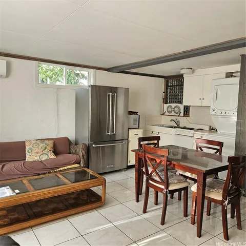 a dining room with furniture and a large window