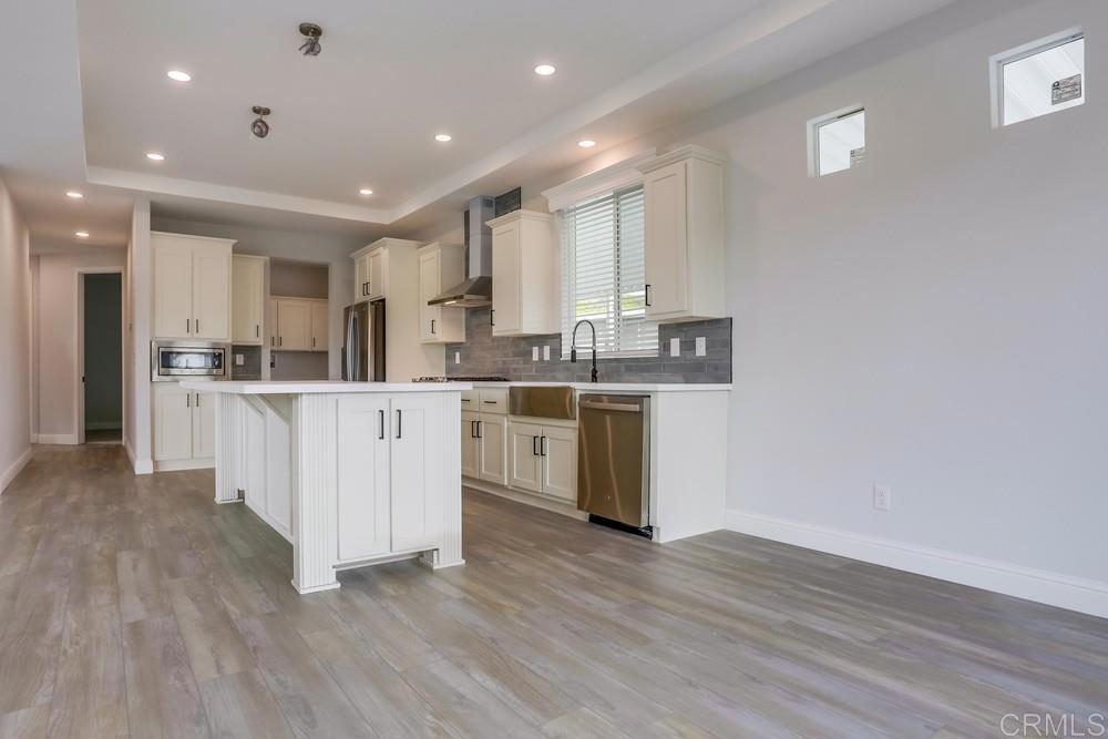 4650 Dulin Road, Unit 45 Fallbrook, CA 92003 - Photo 11 of 42 a kitchen with stainless steel appliances granite countertop a white cabinets a sink a stove a refrigerator and a microwave