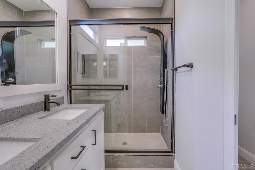 4650 Dulin Road, Unit 45 Fallbrook, CA 92003 - Photo 22 of 42 a bathroom with a granite countertop sink mirror and shower