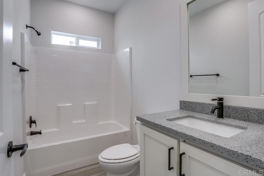 4650 Dulin Road, Unit 45 Fallbrook, CA 92003 - Photo 27 of 42 a bathroom with a granite countertop sink toilet and shower