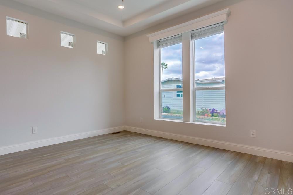 4650 Dulin Road, Unit 45 Fallbrook, CA 92003 - Photo 9 of 42 a view of an empty room with wooden floor and a window