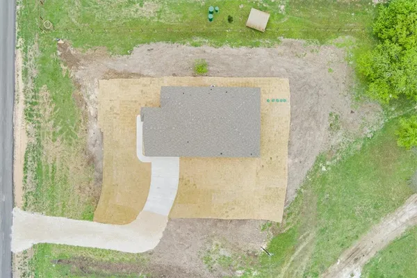 aerial view of a house with a yard