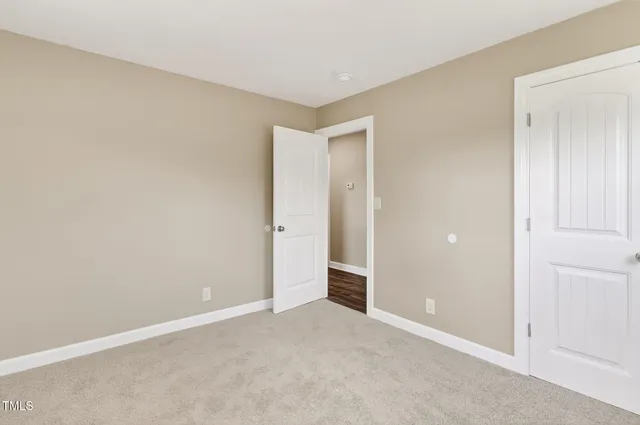 an empty room with closet area