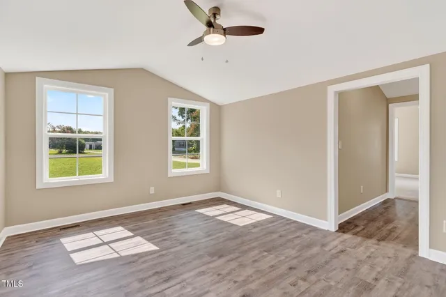 wooden floor in an empty room with a window