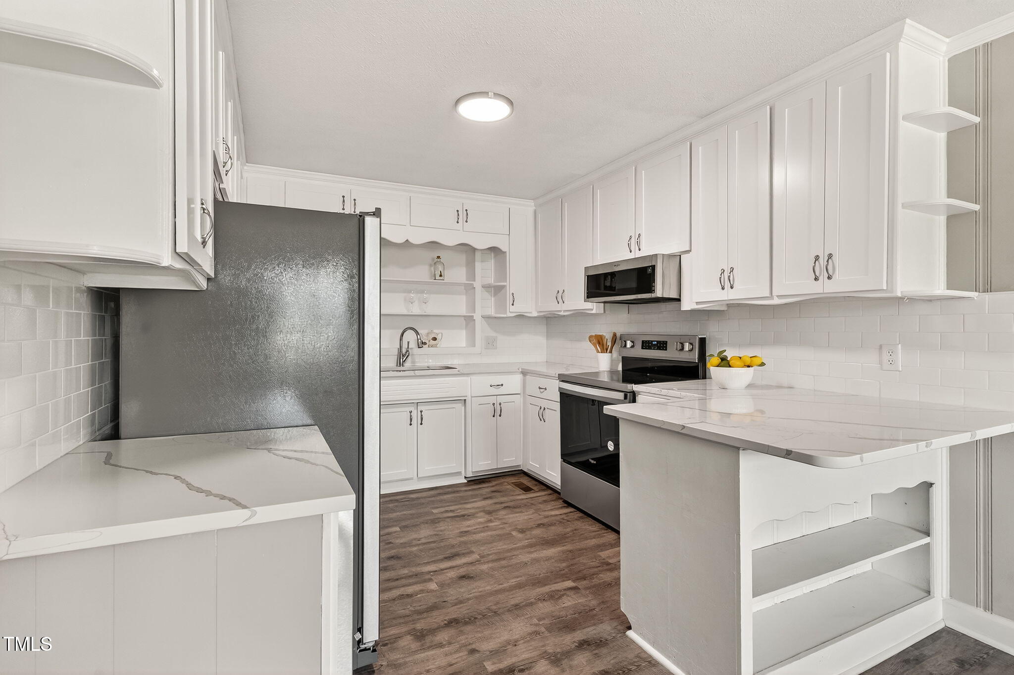 6715 Princeton Kenly Road Princeton, NC 27569 - Photo 5 of 35 a kitchen with a sink a stove top oven and white stainless steel appliances
