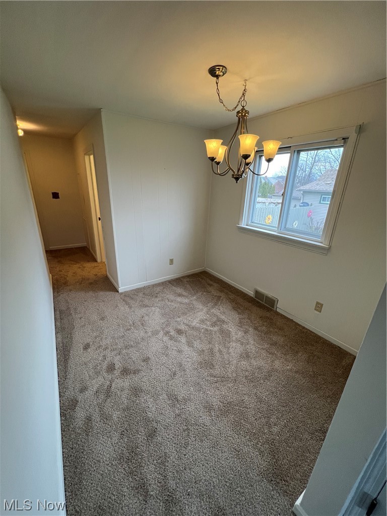 545 7th Street Struthers, OH 44471 - Photo 11 of 17 Spare room with a notable chandelier and carpet