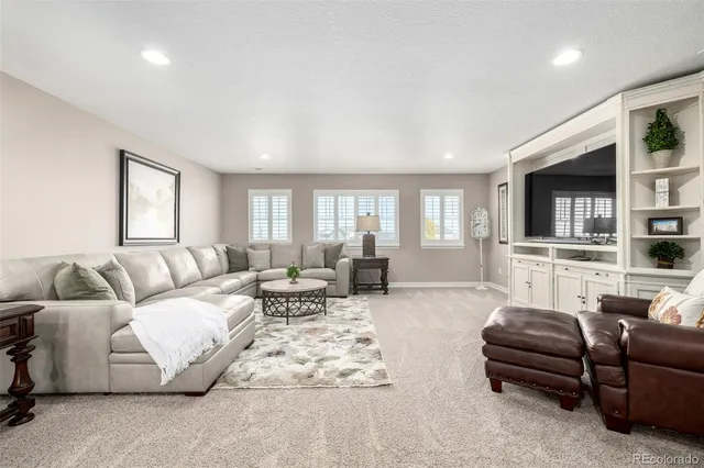 a spacious bedroom with a bed and a chandelier