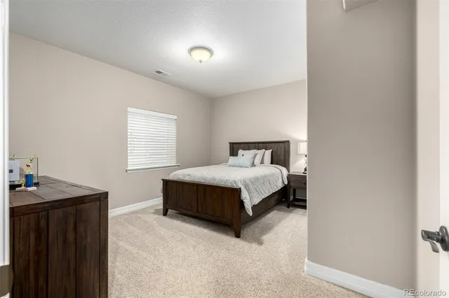 a bathroom with a granite countertop sink a mirror and shower