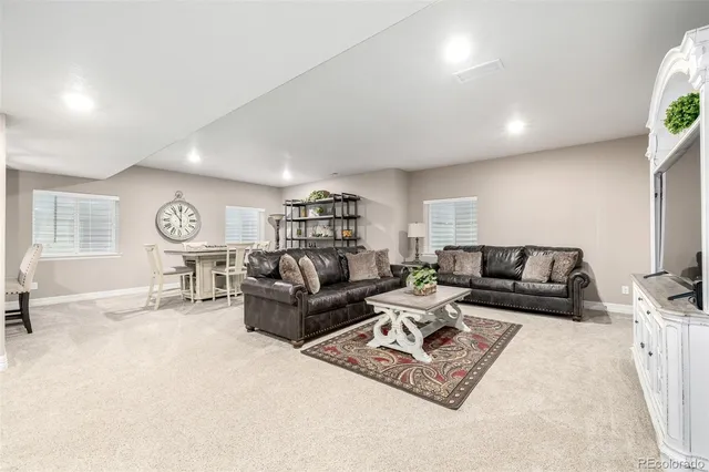 a living room with furniture a air conditioner and a window