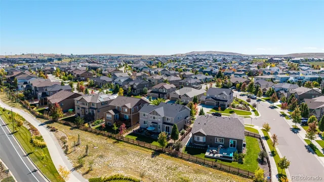 a view of a tennis ground with a table and chairs