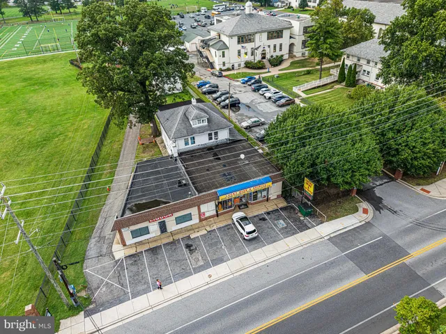 a kitchen with stainless steel appliances kitchen island granite countertop a sink cabinets and wooden floor