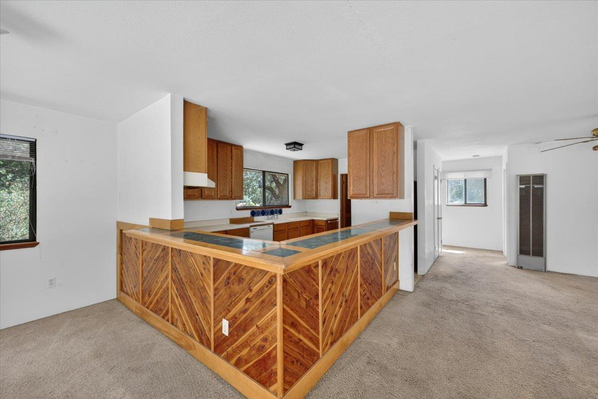46404 Arroyo Seco Road Greenfield, CA 93927 - Photo 22 of 53 a large white kitchen with stainless steel appliances kitchen island granite countertop a sink and cabinets