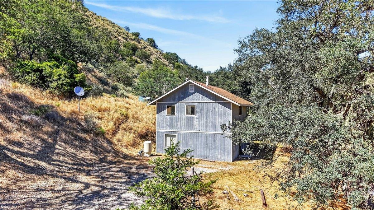 46404 Arroyo Seco Road Greenfield, CA 93927 - Photo 50 of 53 a view of a wooden house with a yard and large trees