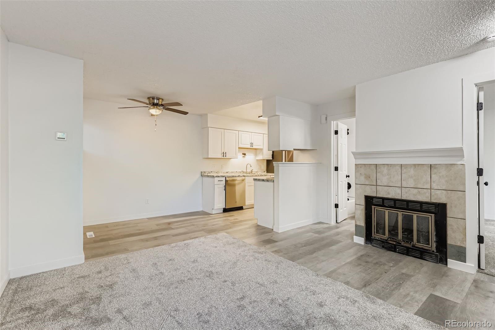 1845 Kendall Street, Unit 103A Denver, CO 80214 - Photo 3 of 11 a view of a livingroom with a fireplace