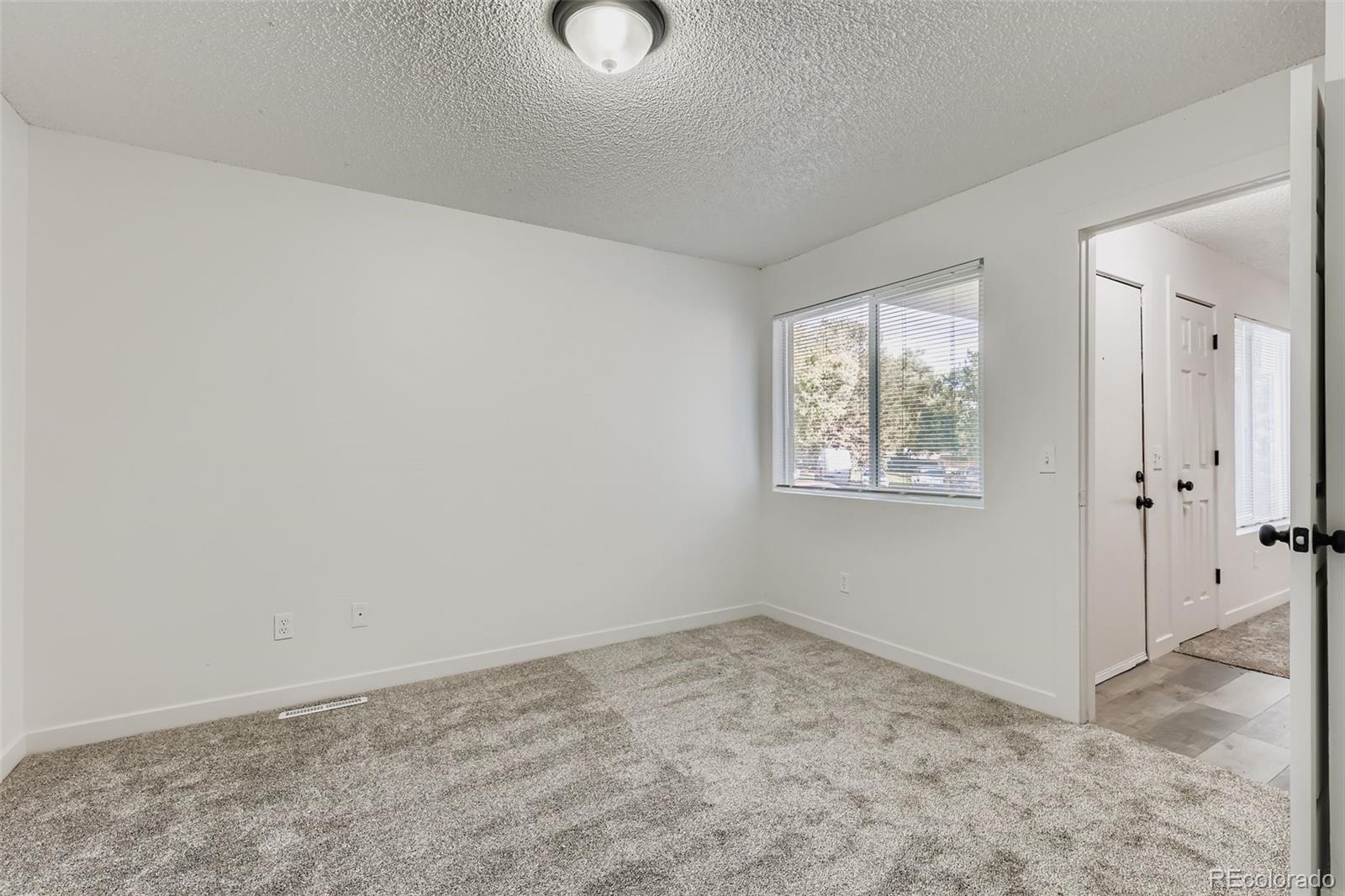 1845 Kendall Street, Unit 103A Denver, CO 80214 - Photo 8 of 11 an empty room with windows
