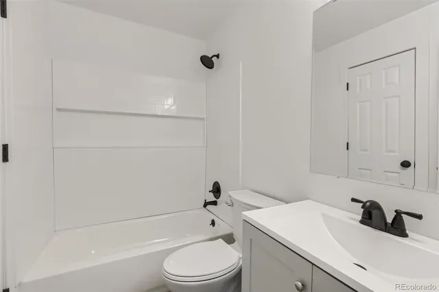 a bathroom with a sink a toilet and bathtub