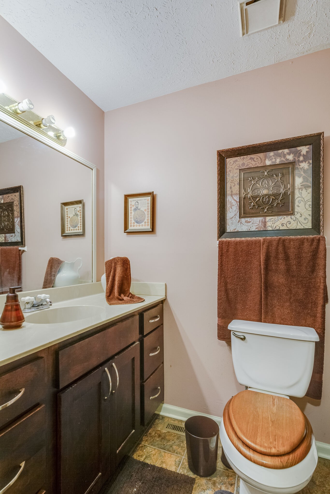 1216 Idlewild Place Madison, TN 37115 - Photo 14 of 24 a bathroom with a toilet a sink and mirror