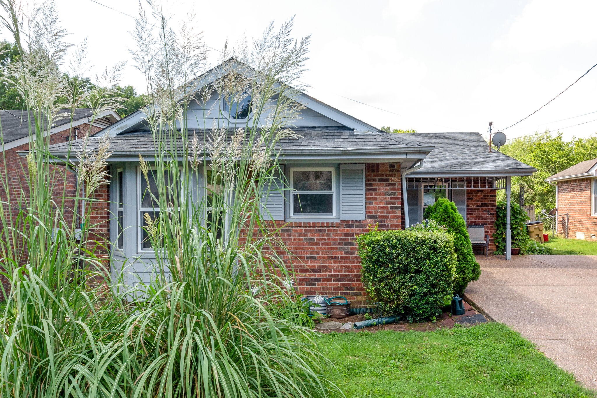 1216 Idlewild Place Madison, TN 37115 - Photo 2 of 24 a front view of a house with garden