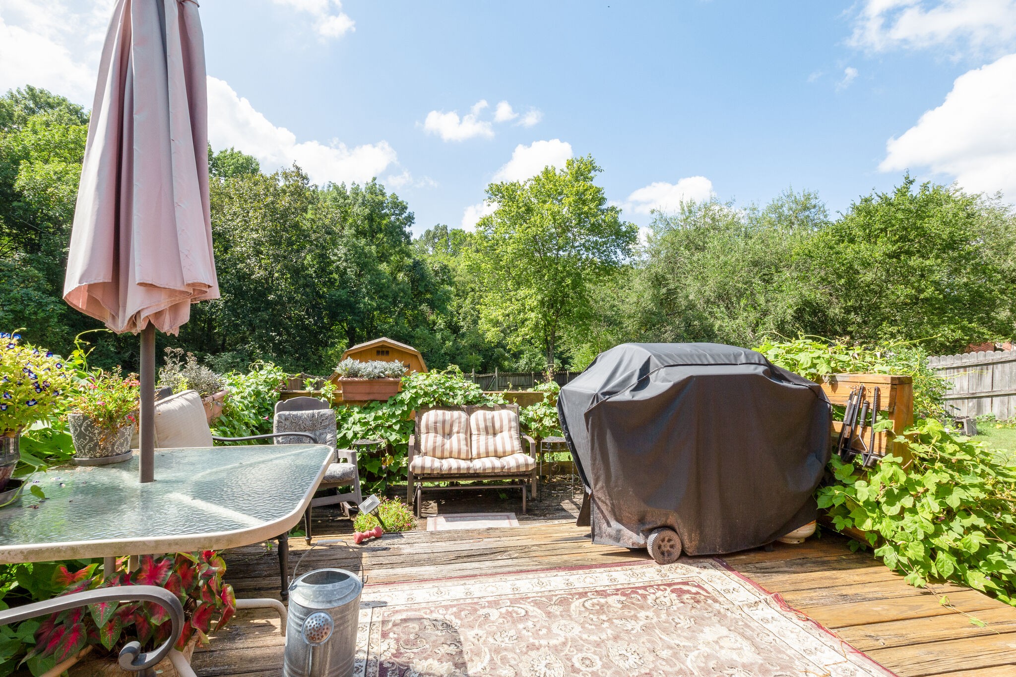 1216 Idlewild Place Madison, TN 37115 - Photo 21 of 24 a view of a patio with a table and chairs under an umbrella