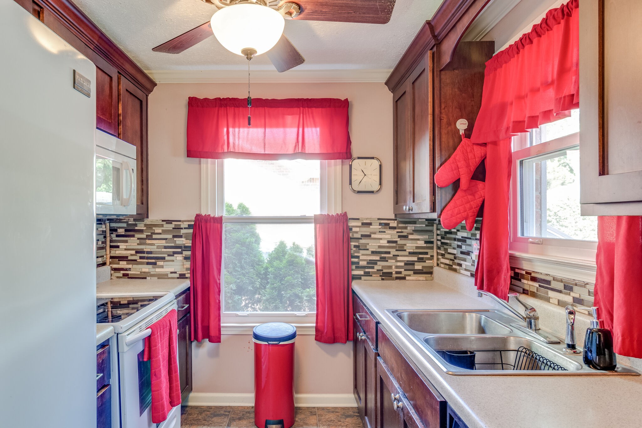 1216 Idlewild Place Madison, TN 37115 - Photo 8 of 24 a kitchen with red cabinets a stove and a window