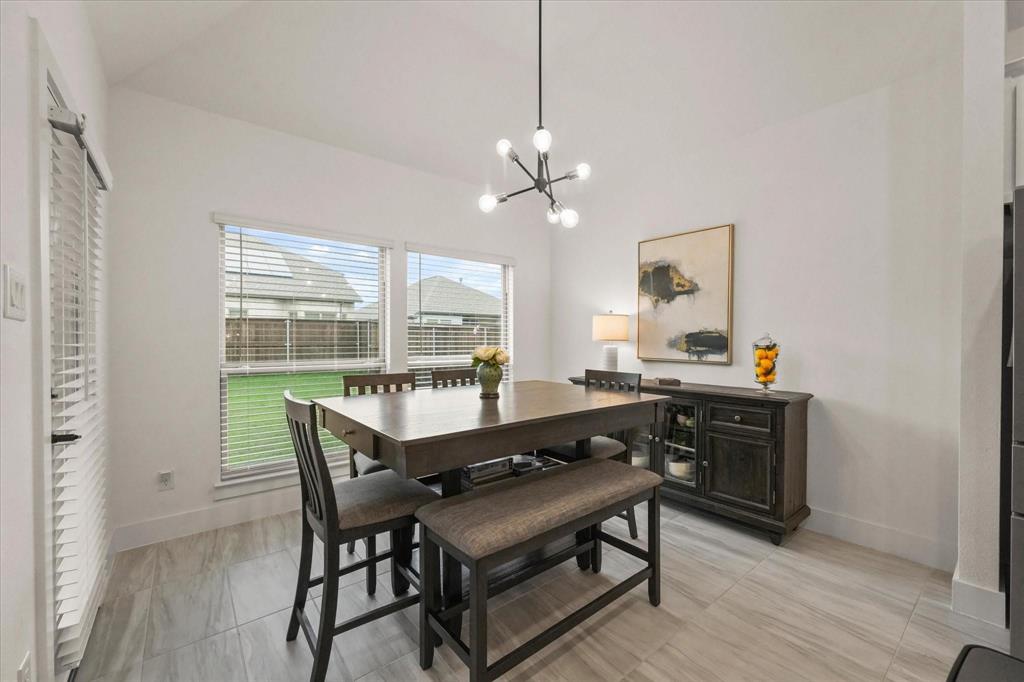 1714 Highwood Road Forney, TX 75126 - Photo 14 of 30 a view of a dining room with furniture window and wooden floor