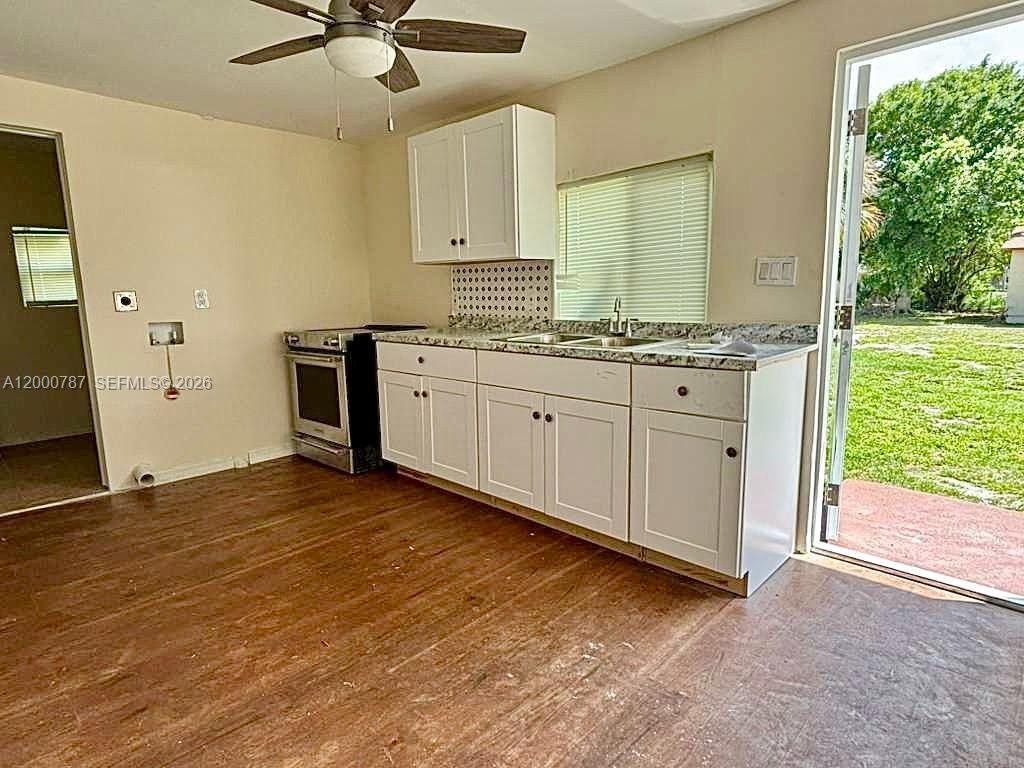 514 North 27th Street, Unit B Fort Pierce, FL 34947 - Photo 2 of 7 a view of a kitchen with a sink and a window