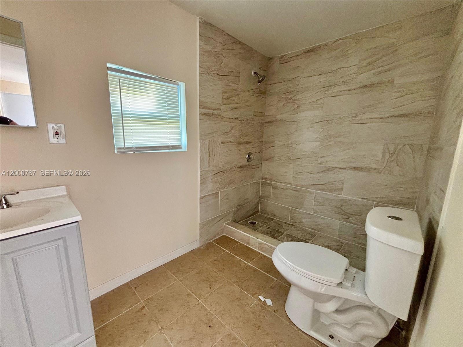 514 North 27th Street, Unit B Fort Pierce, FL 34947 - Photo 5 of 7 a bathroom with a toilet and a shower