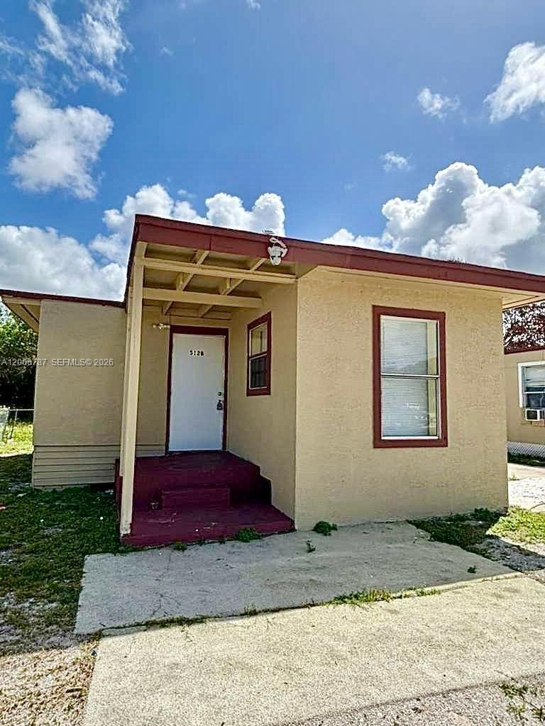 514 North 27th Street, Unit B Fort Pierce, FL 34947 - Photo 6 of 7 a view of a house with a small yard