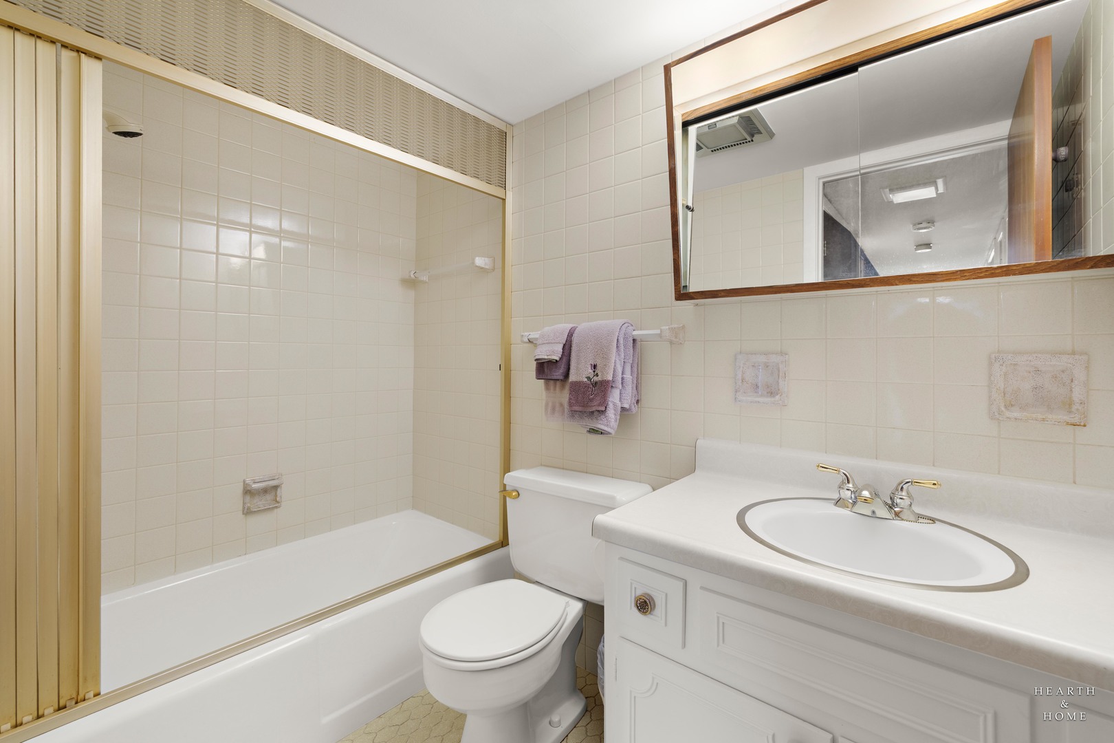 5300 Walnut Avenue, Unit 12B Downers Grove, IL 60515 - Photo 14 of 30 a bathroom with a sink toilet and shower