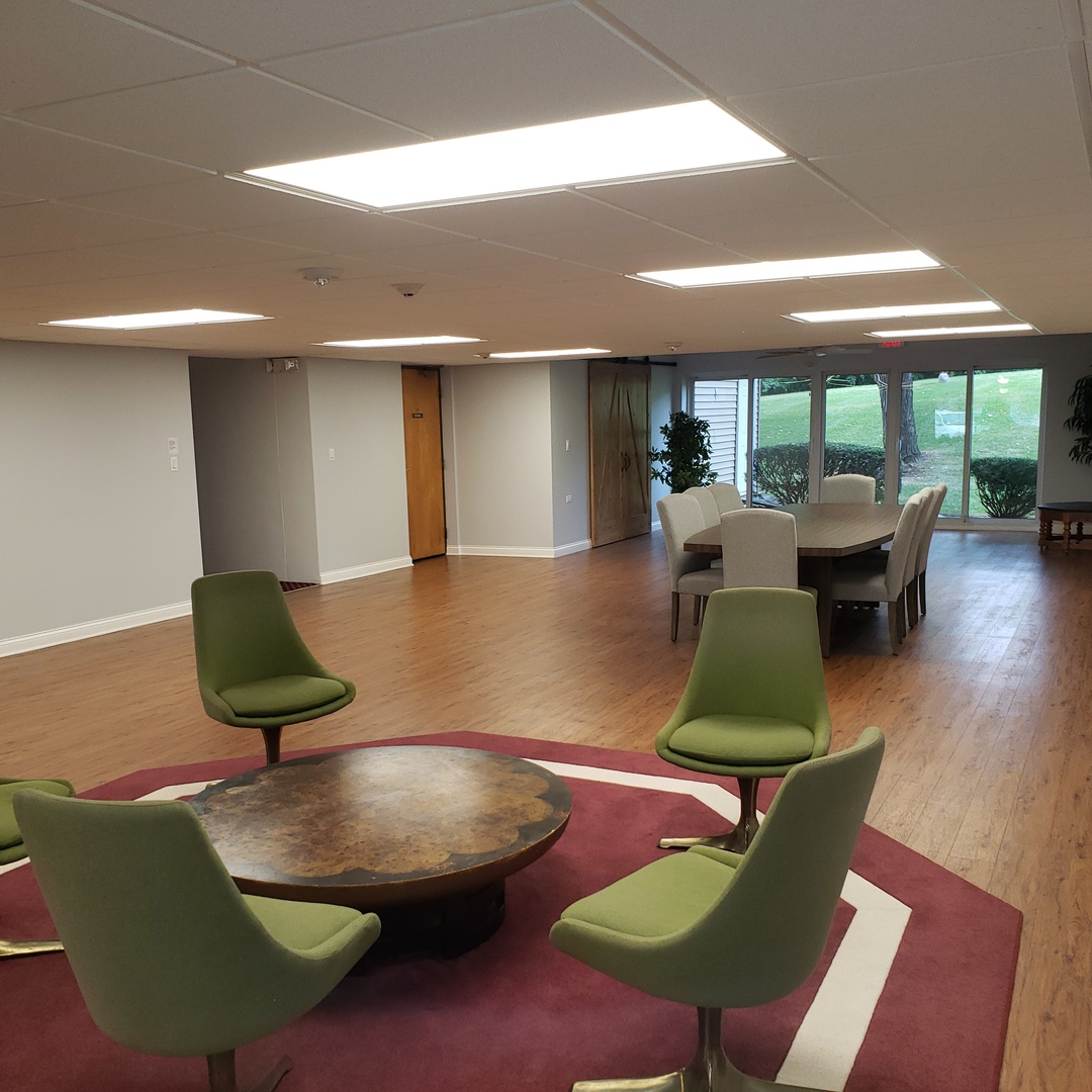 5300 Walnut Avenue, Unit 12B Downers Grove, IL 60515 - Photo 23 of 30 a living room with furniture rug and wooden floor