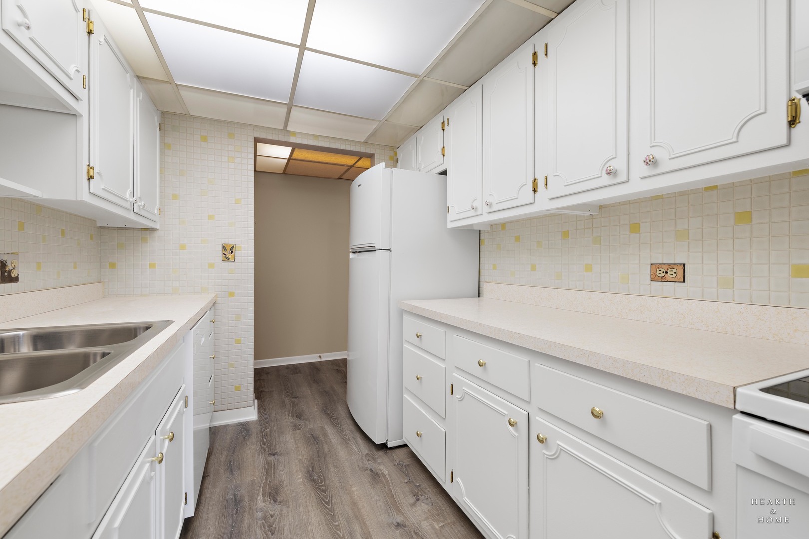 5300 Walnut Avenue, Unit 12B Downers Grove, IL 60515 - Photo 7 of 30 a kitchen with granite countertop a white stove top oven and white cabinets