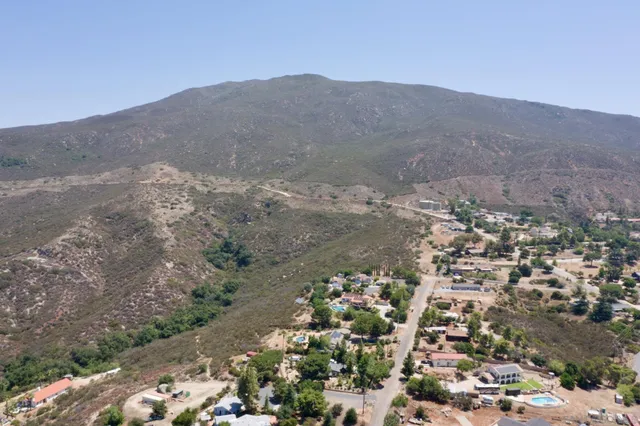 a view of a road with mountains in the background