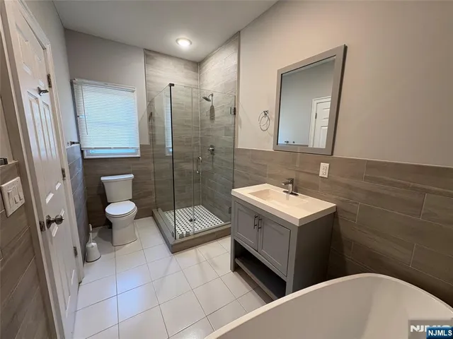 a bathroom with a sink a toilet and a shower