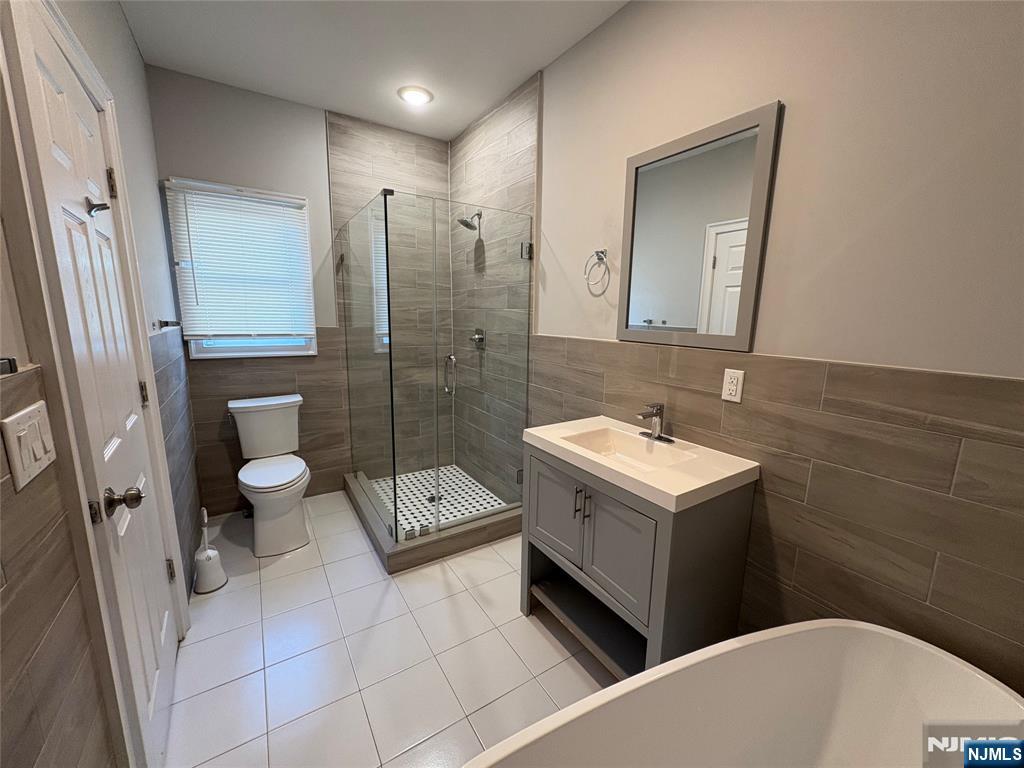 274 Governor Street, Unit 2 Paterson, NJ 07501 - Photo 12 of 15 a bathroom with a sink a toilet and a shower