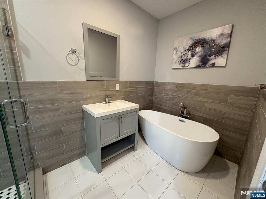 274 Governor Street, Unit 2 Paterson, NJ 07501 - Photo 13 of 15 a bathroom with a sink mirror and toilet