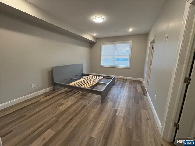 a view of room with wooden floor