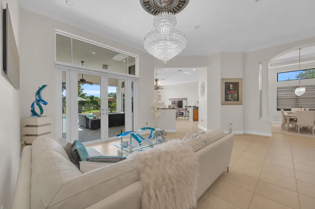 a living room with furniture and a chandelier