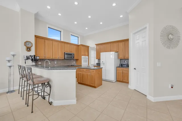 a kitchen with stainless steel appliances a refrigerator and a stove top oven