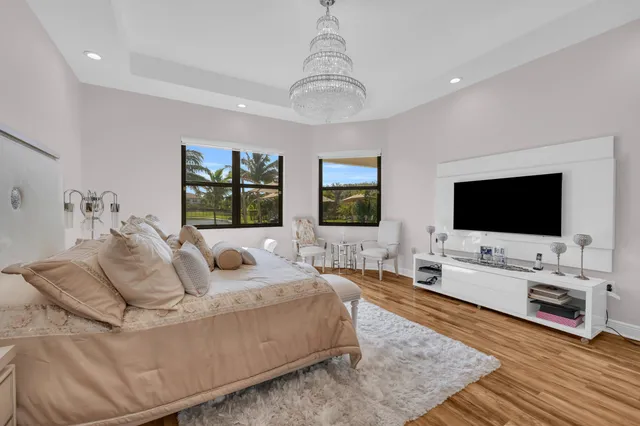 a bedroom with a bed and a chandelier