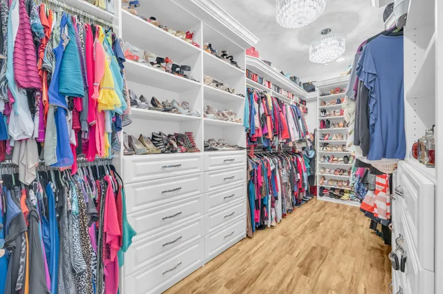 a spacious bathroom with a granite countertop sink a mirror a bathtub and window