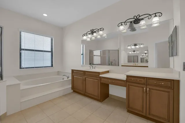a bathroom with a granite countertop sink mirror vanity and toilet