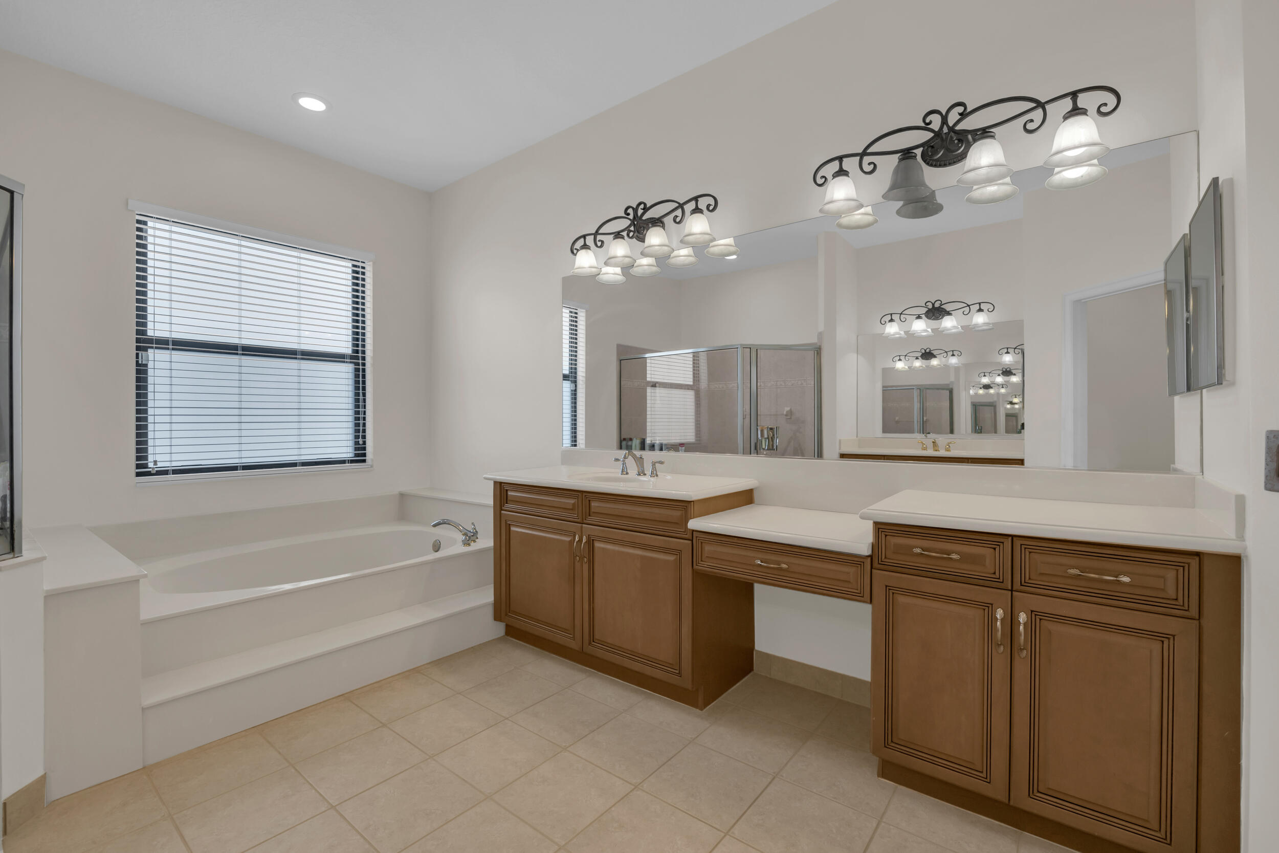 15182 Southwest 35th Street Davie, FL 33331 - Photo 28 of 53 a spacious bathroom with a granite countertop sink a mirror a bathtub and window