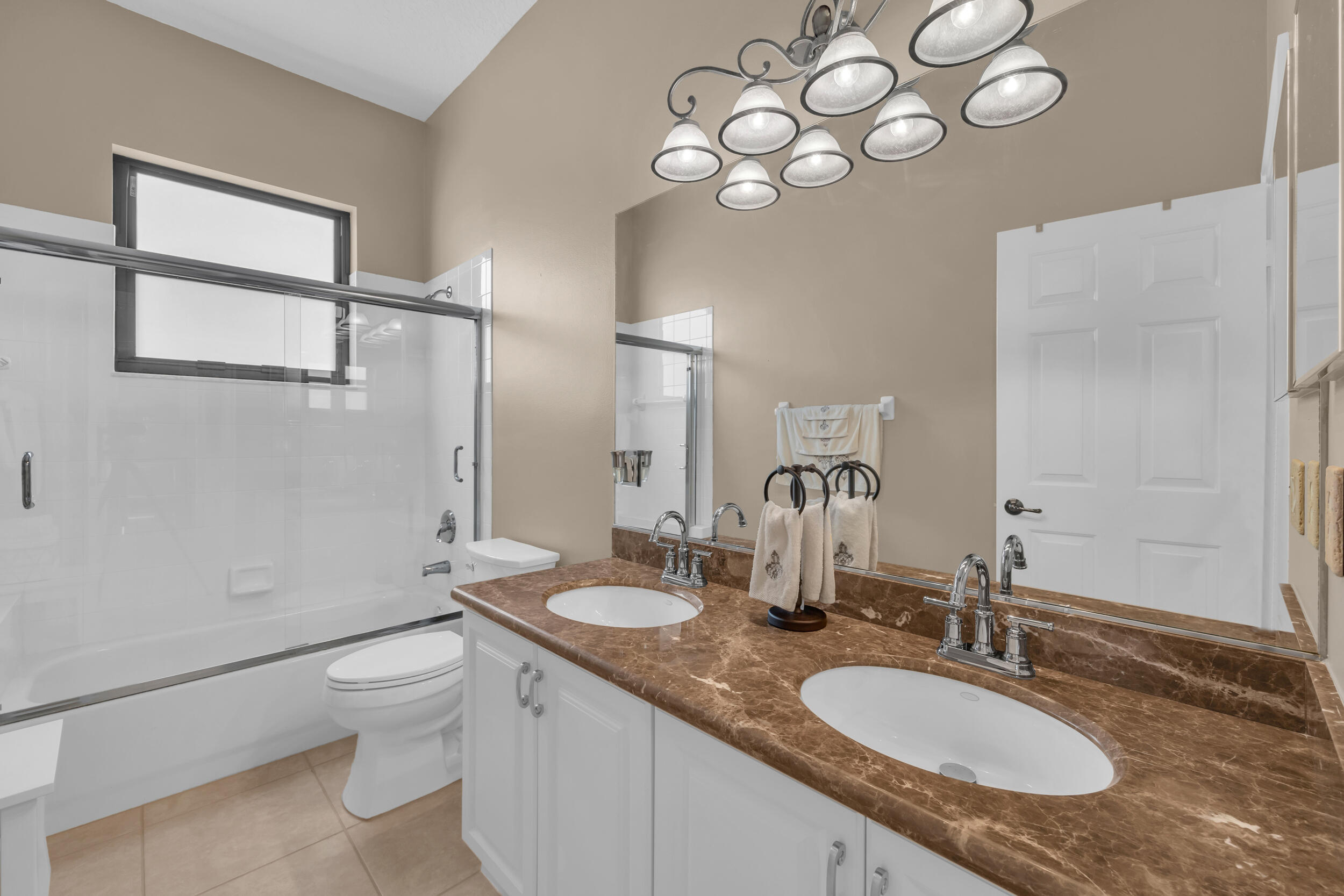 15182 Southwest 35th Street Davie, FL 33331 - Photo 36 of 53 a bathroom with a granite countertop sink a toilet and a mirror