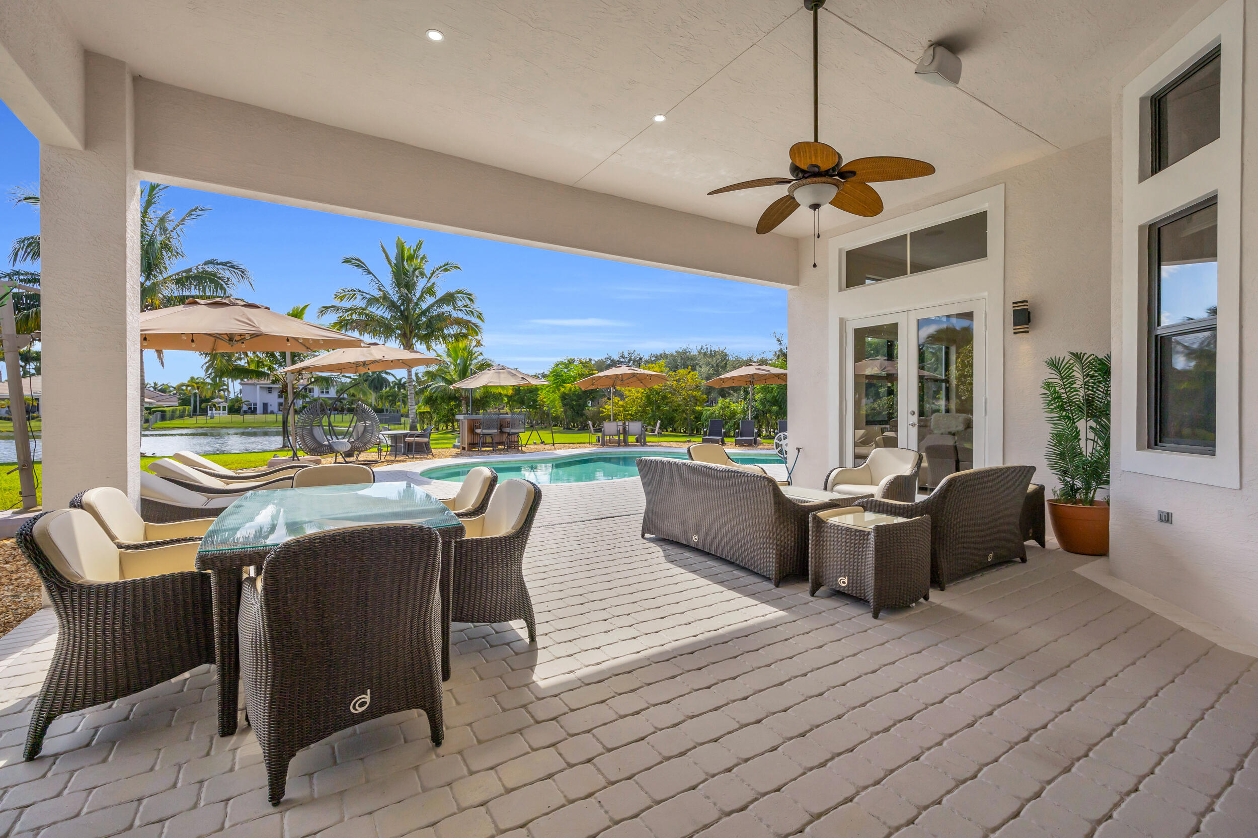 15182 Southwest 35th Street Davie, FL 33331 - Photo 38 of 53 a dining room with furniture a floor to ceiling window and a table