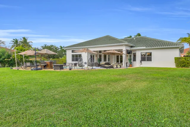 a swimming pool with an outdoor space and seating area