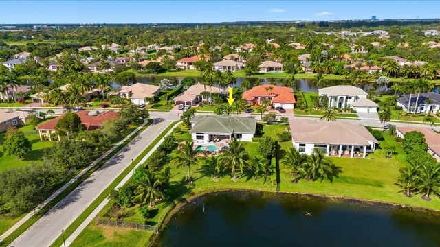 an aerial view of lake and residential houses with outdoor space