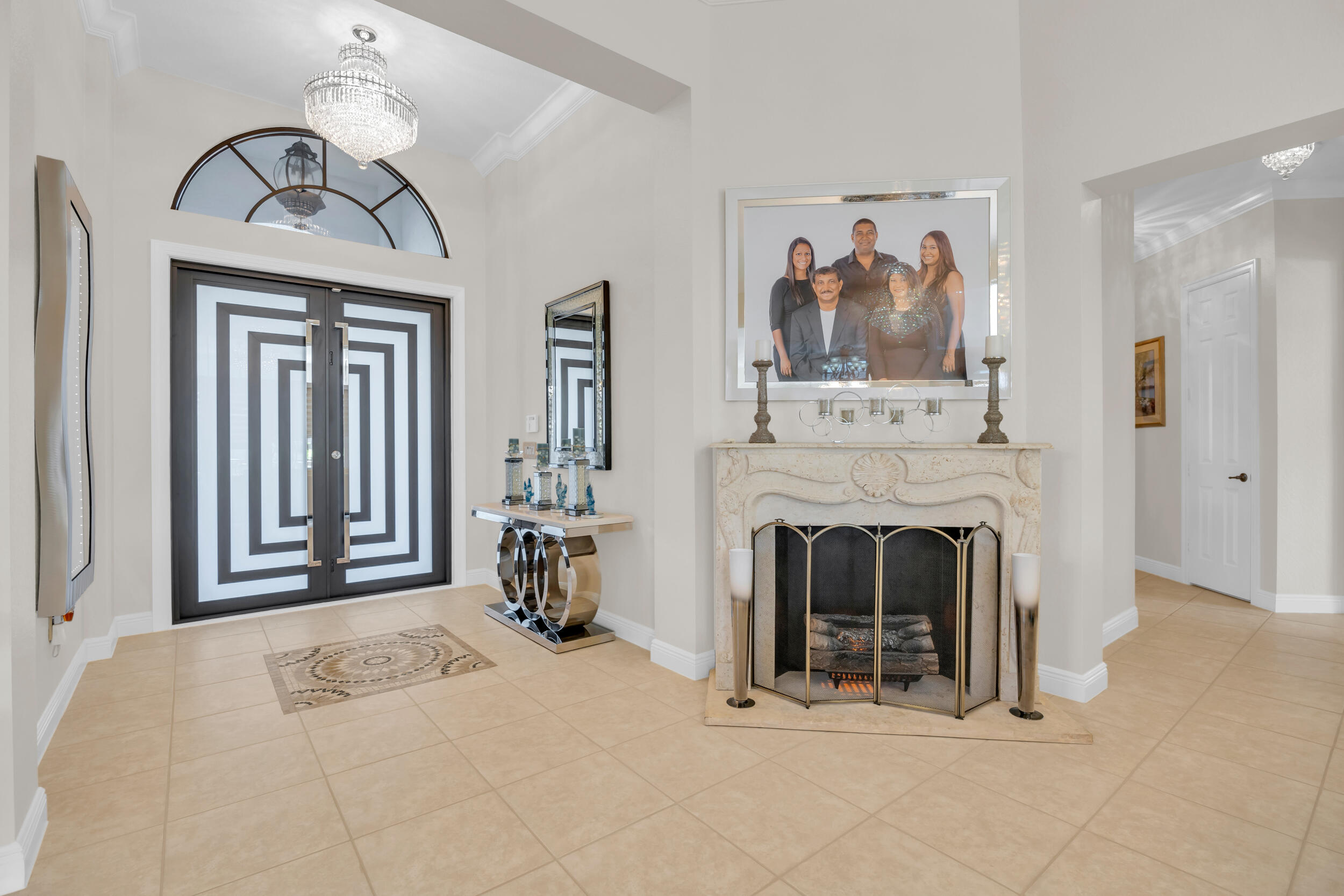 15182 Southwest 35th Street Davie, FL 33331 - Photo 8 of 53 a view of a livingroom with a fireplace and chandelier