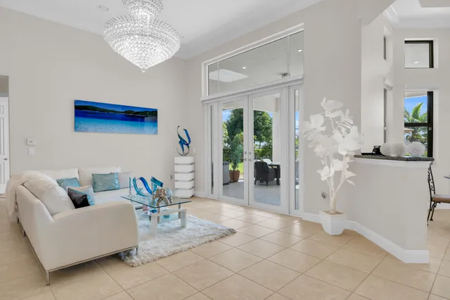 a living room with furniture and a chandelier